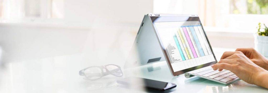Image of hands on the laptop - illustrating working on cost strategy.